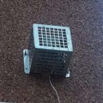 an-electronic-security-device-enclosed-inside-a-protective-metal-vandal-cage