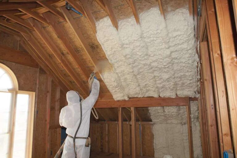 How Does Spray Foam Insulation Work? A Complete Homeowner’s Guide a-professional-worker-applying-spray-form-insulation-to-the-wooden-frame-of-an-attic-or-ceiling