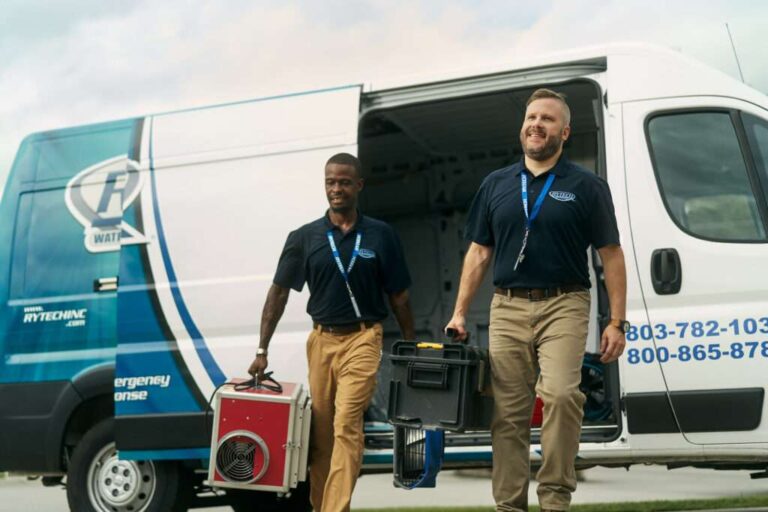 7 Best Water Damage Restoration Companies in Atlanta (2026 Ranked) two-male-water-damage-restoration-technicians-are-walking-forward-both-are-holding-piece-of-equipment