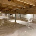 the-area-beneath-a-house-cleanly-lined-with-a-thick-white-plaster-vapor-barries-covering-the-ground-and-pillars