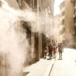 a-city-street-equipped-with-a-cooling-mist-system-to-help-pedestriians-cope-with-extreme-heat