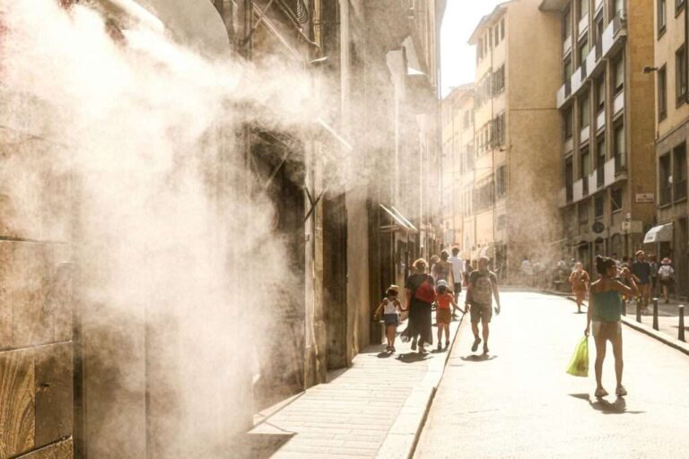 How Heat Waves Strain the Grid and Change the Way We Cool Our Homes a-city-street-equipped-with-a-cooling-mist-system-to-help-pedestriians-cope-with-extreme-heat